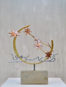 Forged metal sculpture of moon, stars and river